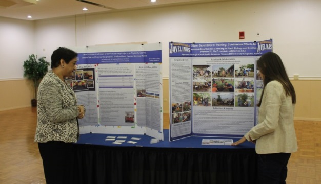 Professor Goswami Looking at a Student Poster Presentation