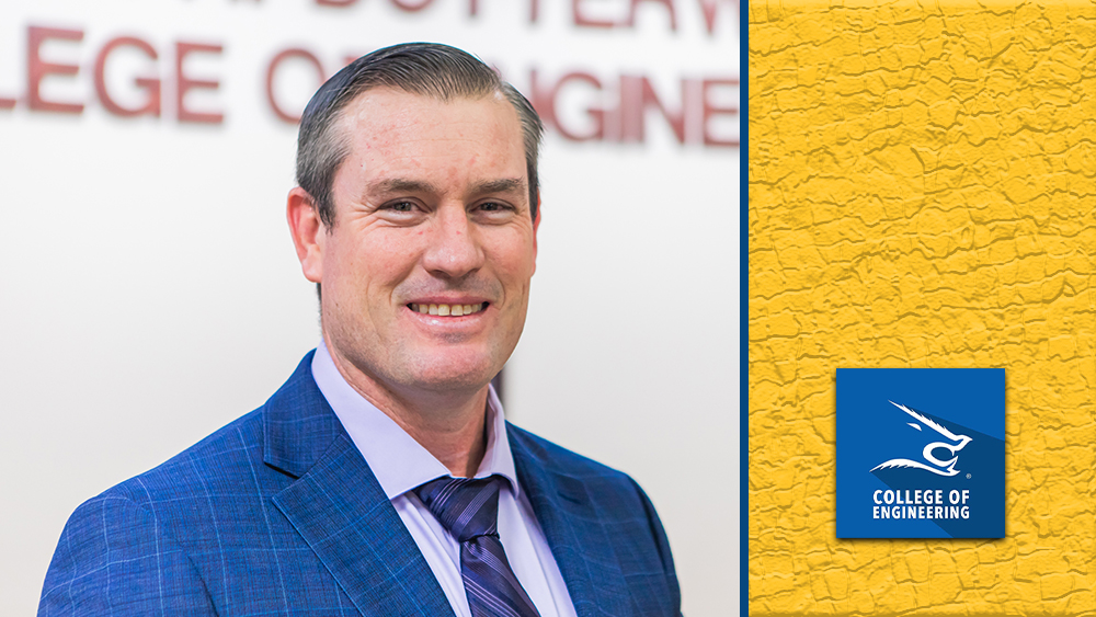 A portrait of engineering student Benjamin Mills smiling confidently.