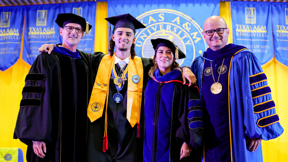 Anthony Zane Anderson stands in graduation regalia with Provost Dr. James Palmer, Dean Dr. Heidi A. Taboada, and President Dr. Robert H. Vela Jr. at a Texas A&M University-Kingsville commencement ceremony.