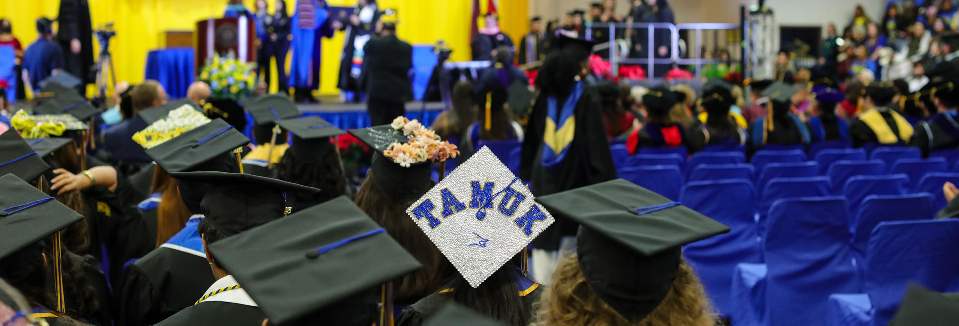 Students holding deplomas at the commencement ceremony