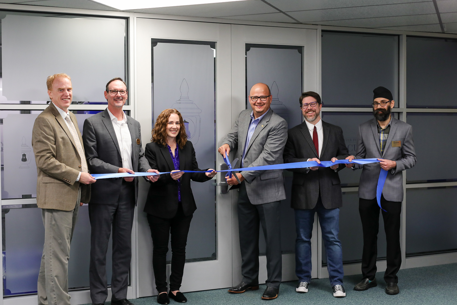 President Vela and Dr. Shipherd cutting the ribbon to open the CFE, flanked by 4 other people