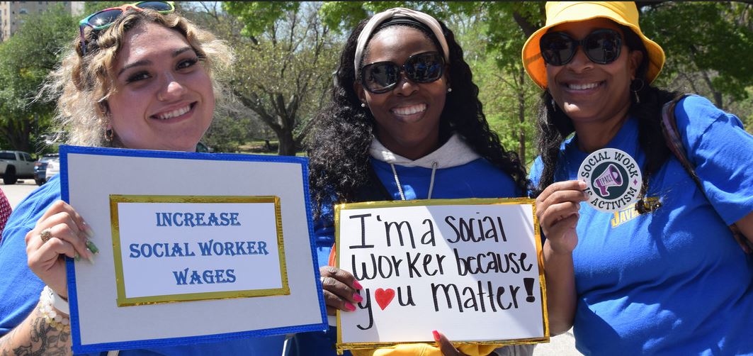 Social Work Students Holding Signs