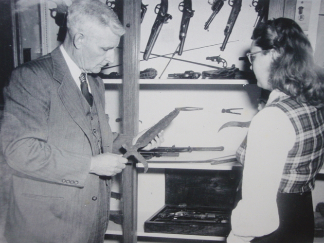 Conner showing the collection to a student