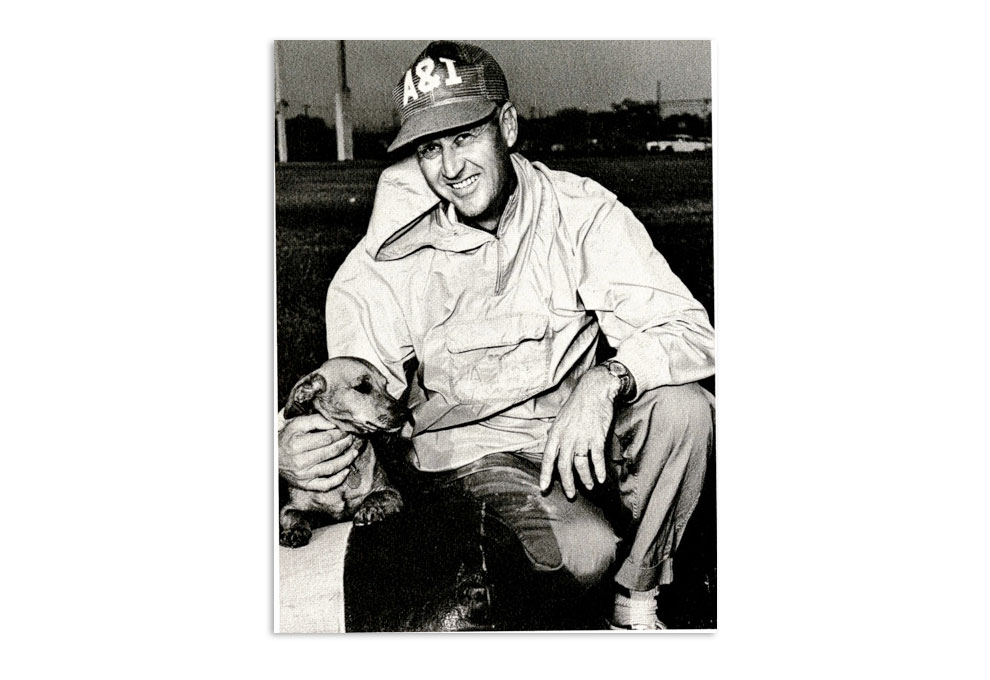 Gil Steinke poses with pet dachshund for retirement photo
