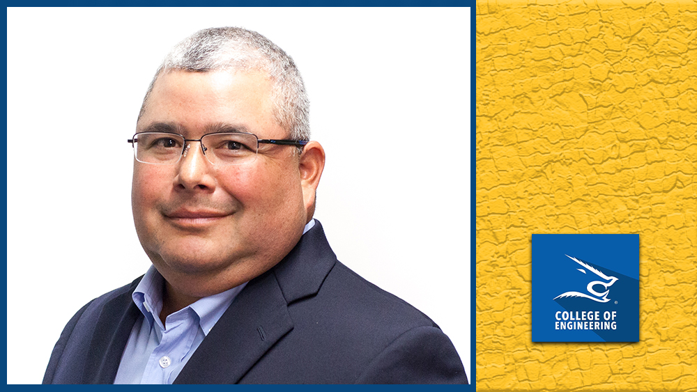 A professional headshot of Jeffrey Torres in a dark suit and light blue shirt, smiling confidently against a white background.