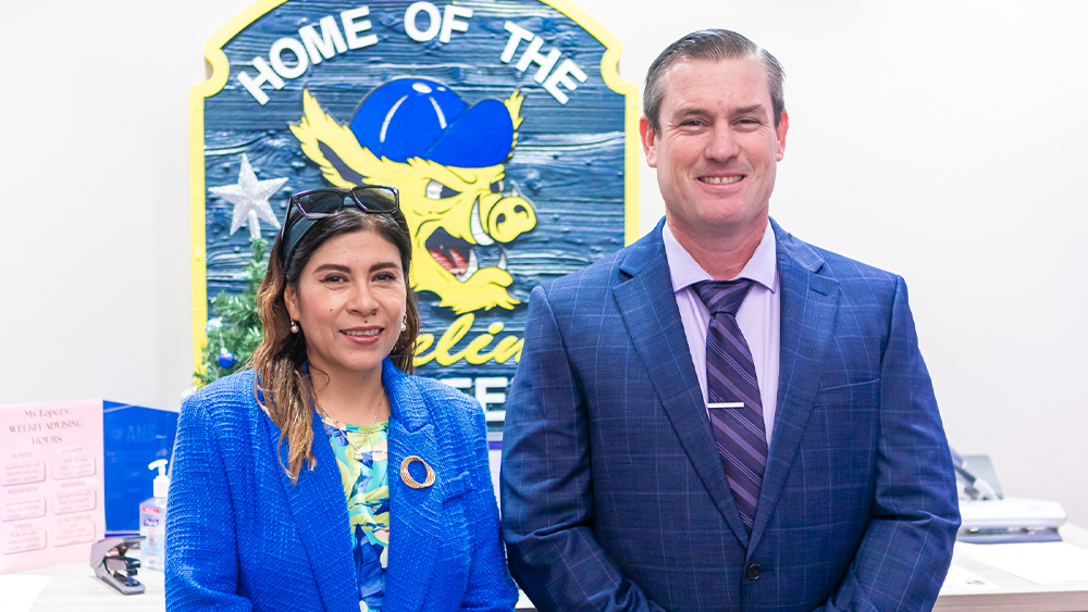 Benjamin Mills stands beside Dean Heidi A. Taboada, both smiling.