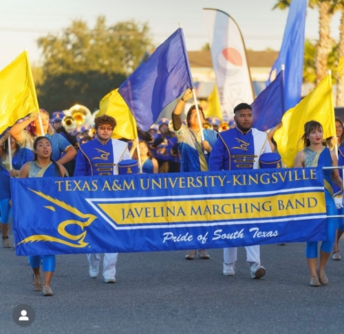 Students walking with homecoming banner in parade
