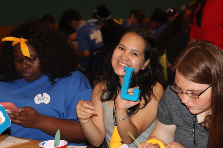 Campers painting letter J's 