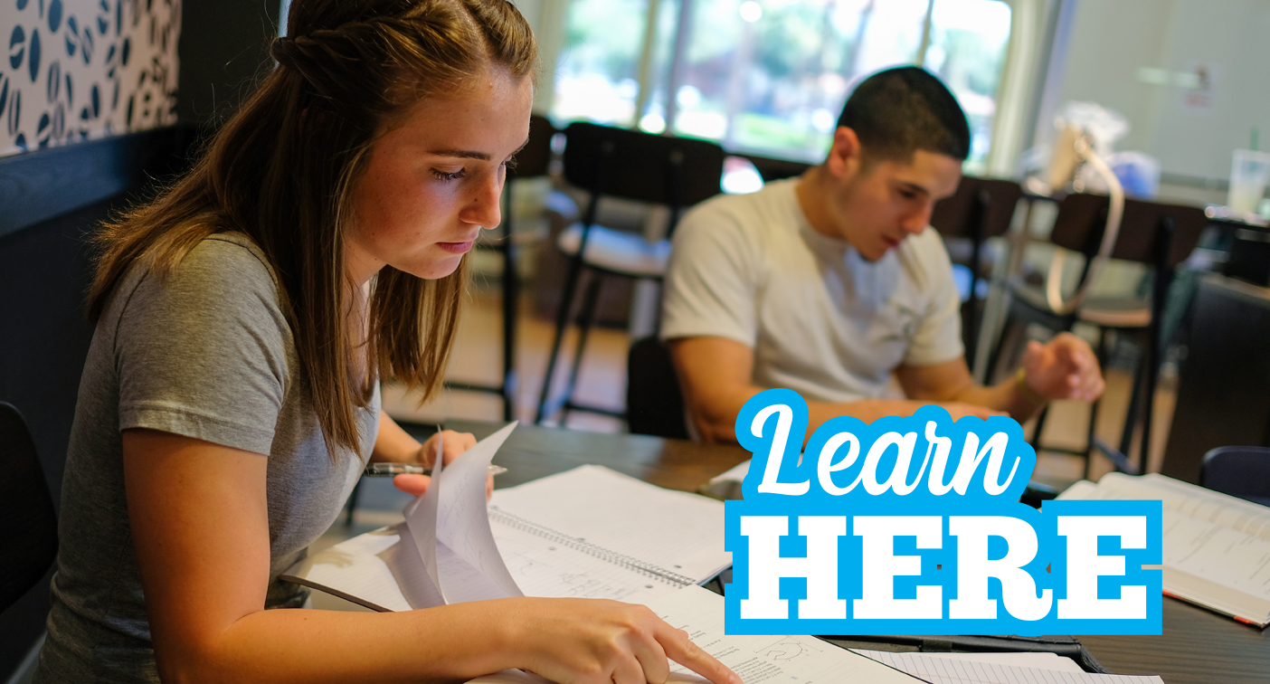 Two students studying in the local coffee shop with text that reads Learn Here