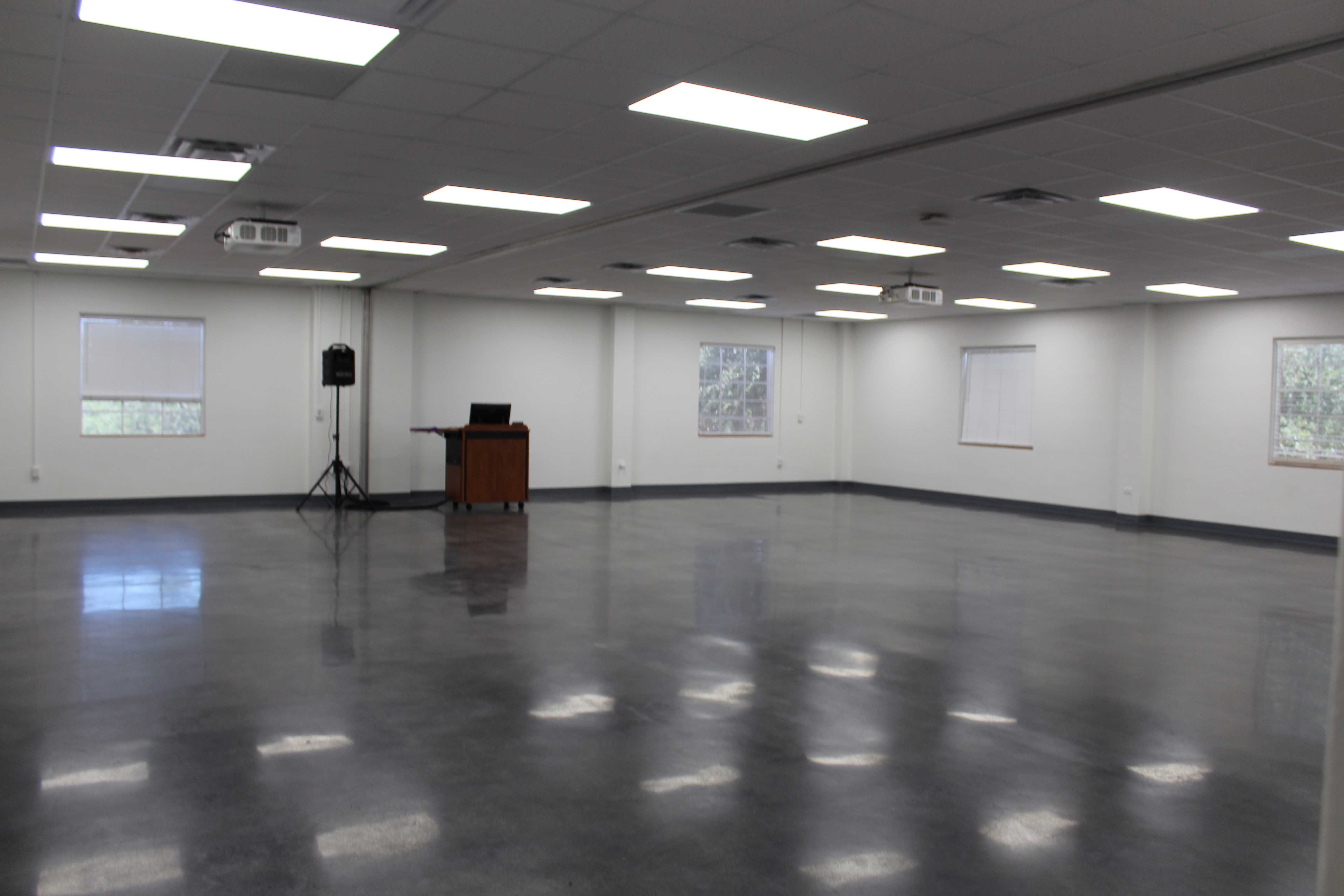 Room 221 has been refurbished with fresh white paint and a blue-grey epoxy flooring.