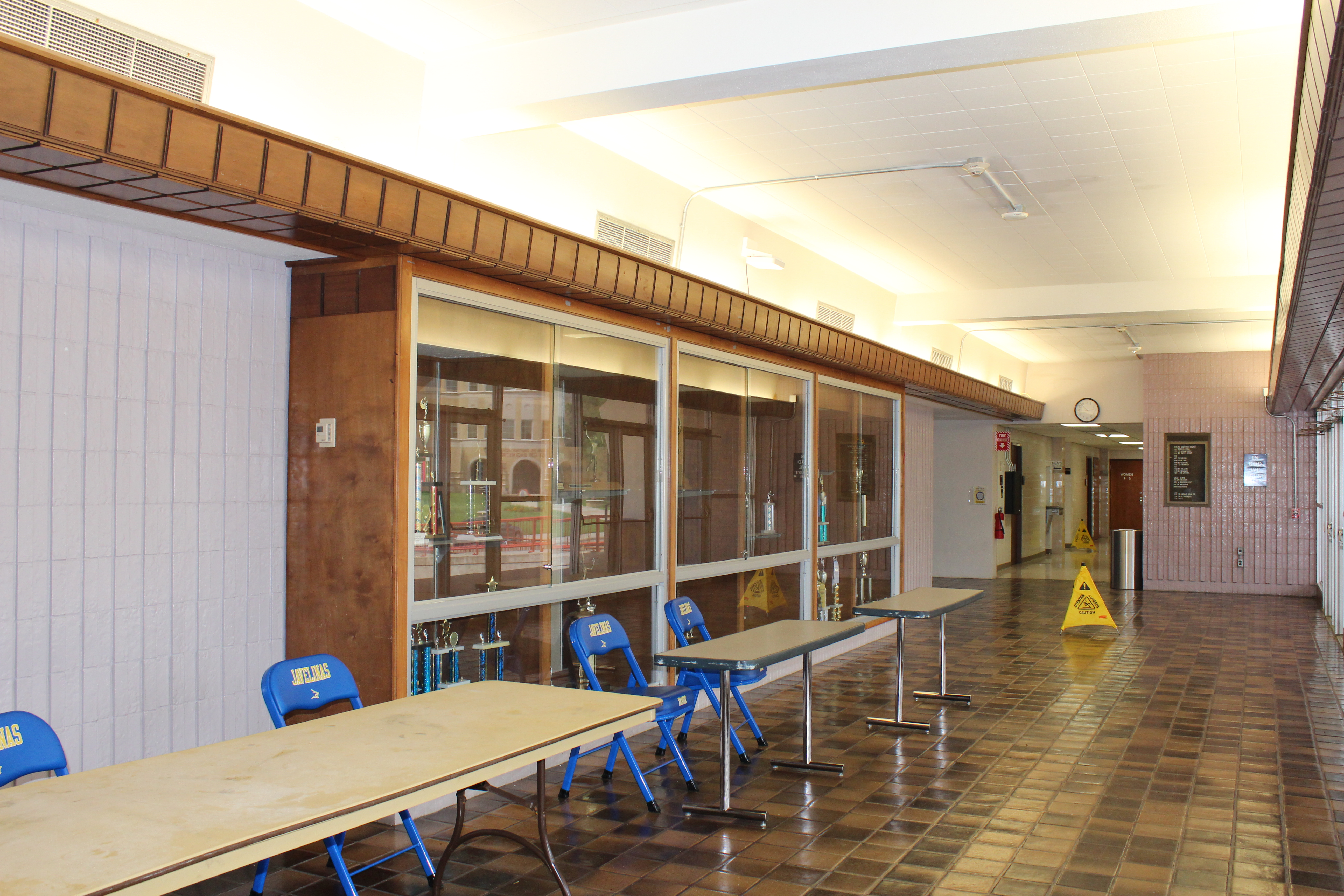 The lobby of the SPEC, with a few tables oriented towards the doors.