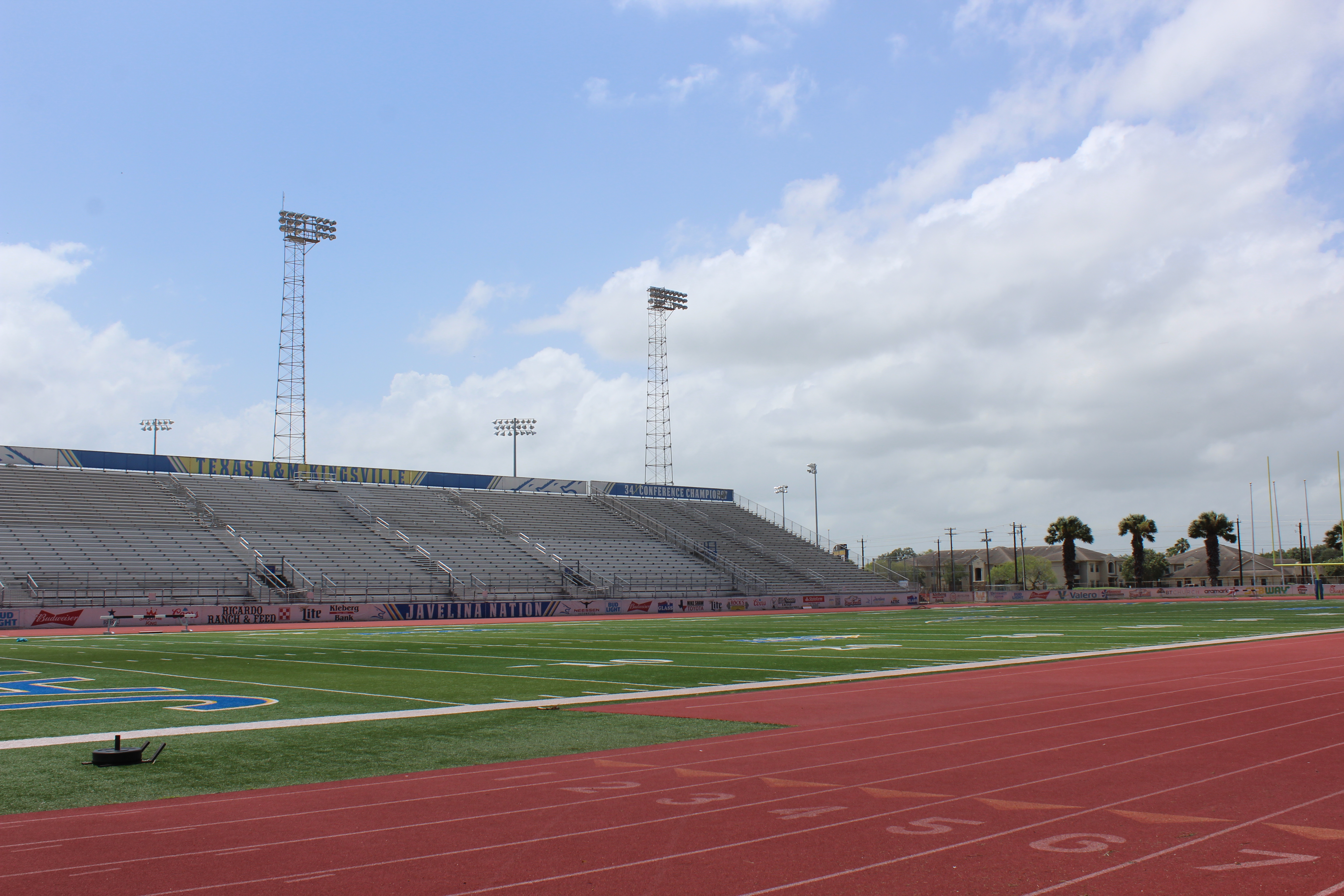 An image of the stadium's football turf and the bleachers on the other side of the field.
