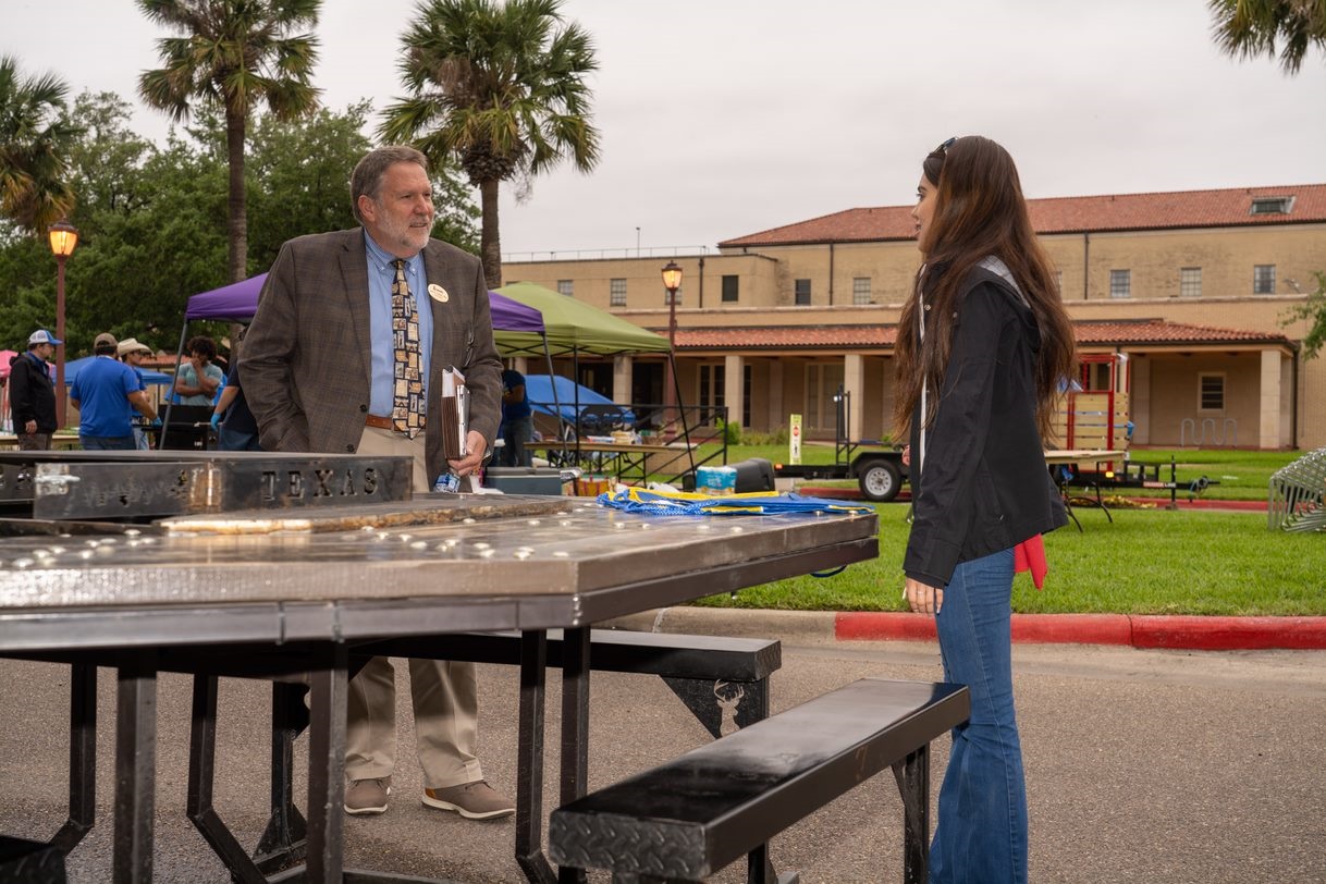 Casandra Gonzalez, a member of the Kaufman High School FFA Agriculture Mechanics Show Team, right, had the opportunity to talk with Dr. James Hallmark, interim president of Texas A&M University-Kingsville, during the Agricultural Mechanics Project Show held on campus Tuesday, April 26. Gonzalez entered a Hibachi Picnic Table in the annual competition. 