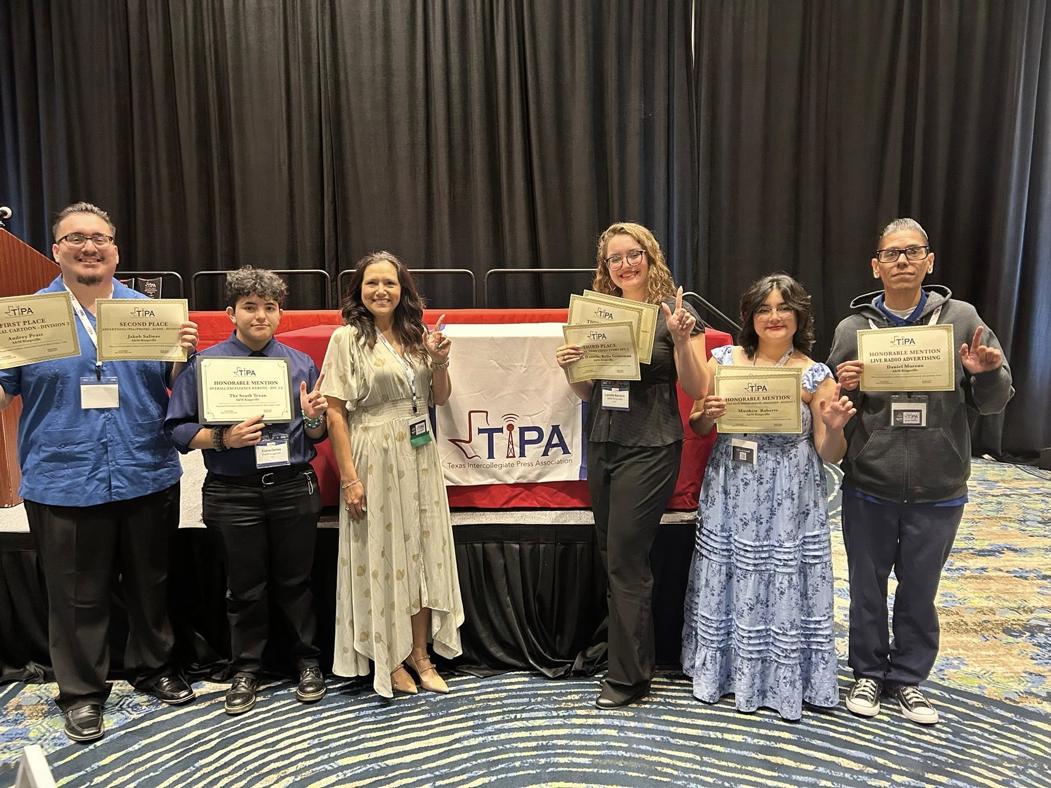 Six members of The South texan stand in line posing for photos with award certificates