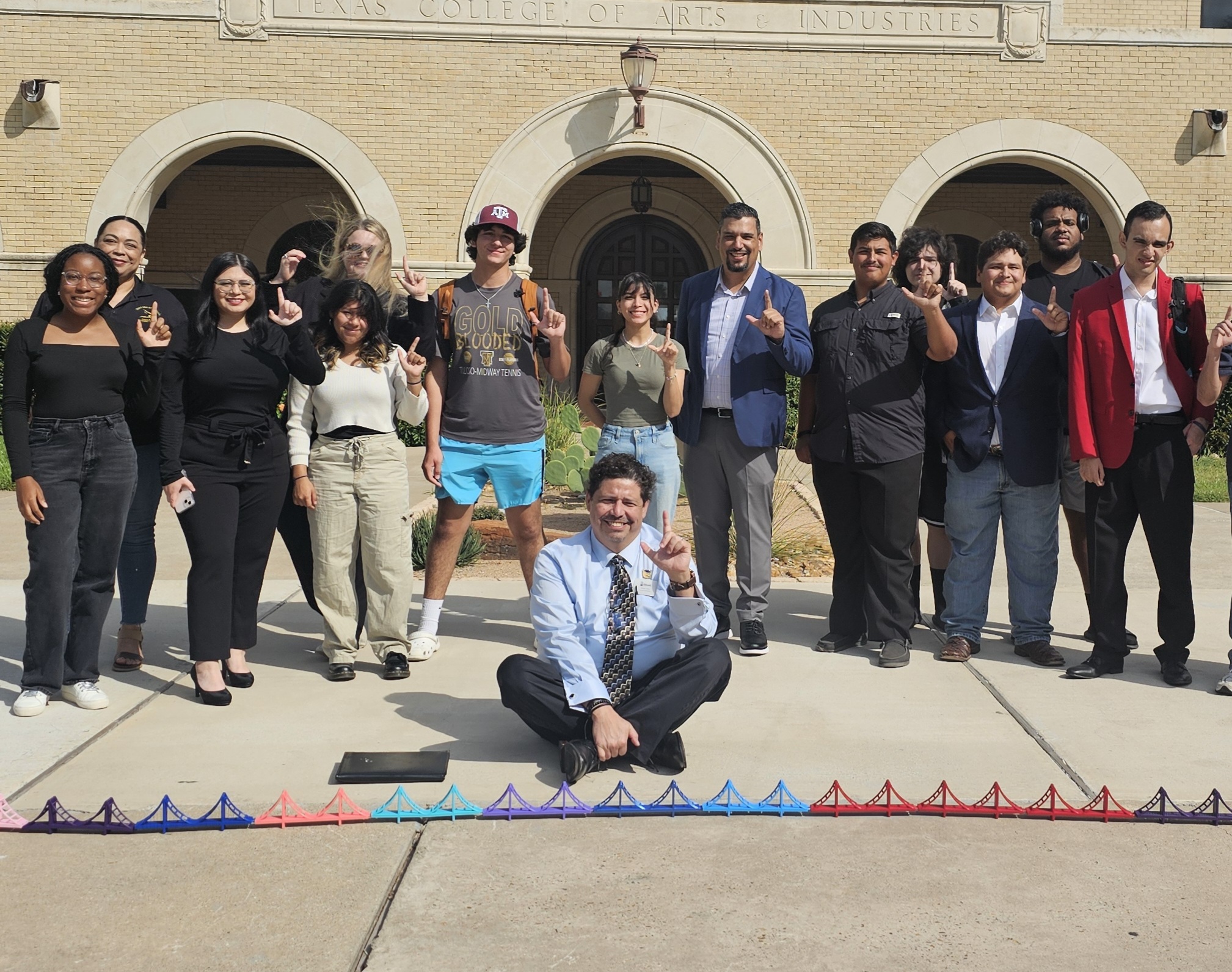 Group photo of TAMUK student posing with Daniel Arias outside College Hall