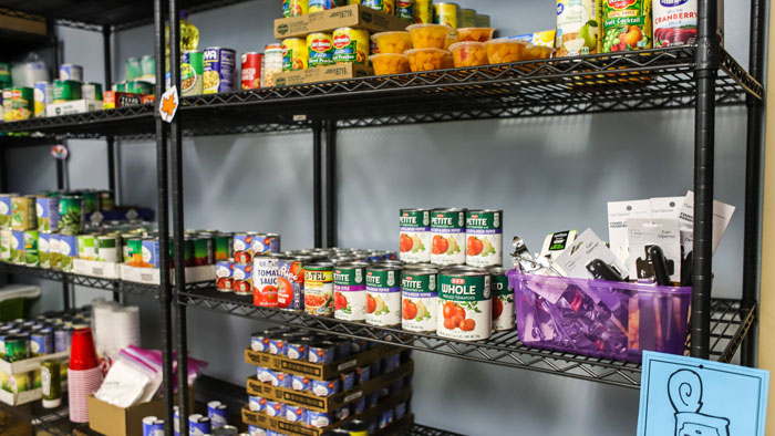 Storage shelves in the Javelina Care Closet showing various brands of canned food.