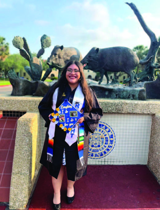 Stephany standing in front of the university javelina statues and college hall