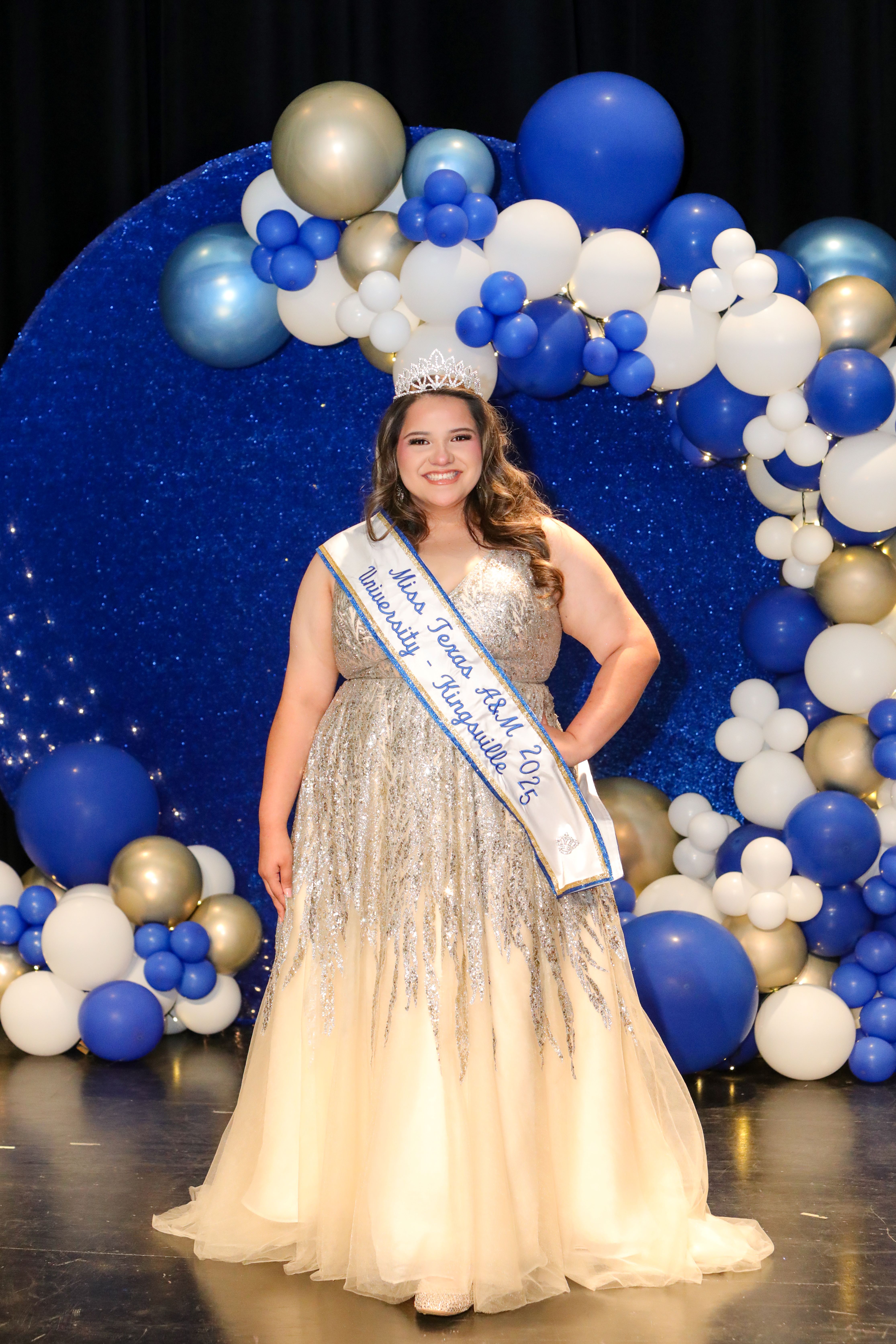 One pageant women smiling for camera. 
